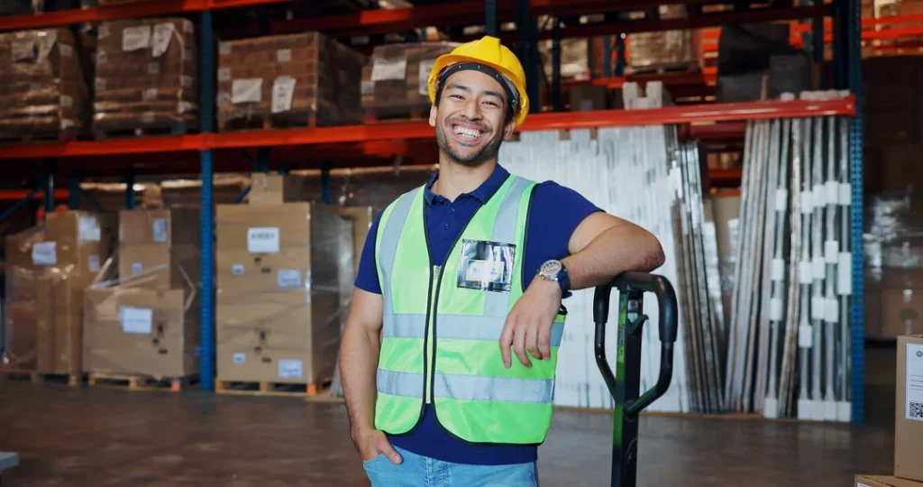happy-worker-posing-in-warehouse-with-forklift-eurocruitment